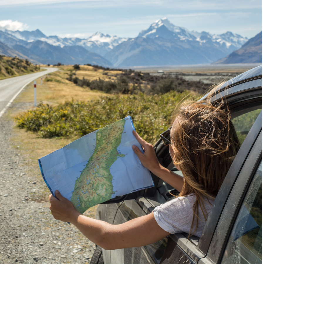A driver leaning out the window with a map